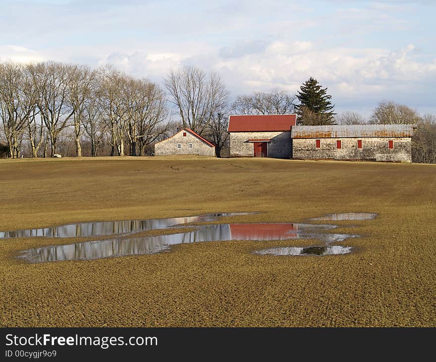 A view of a colorful farm and a large reflecting puddle in Holmdel New Jersey. A view of a colorful farm and a large reflecting puddle in Holmdel New Jersey.