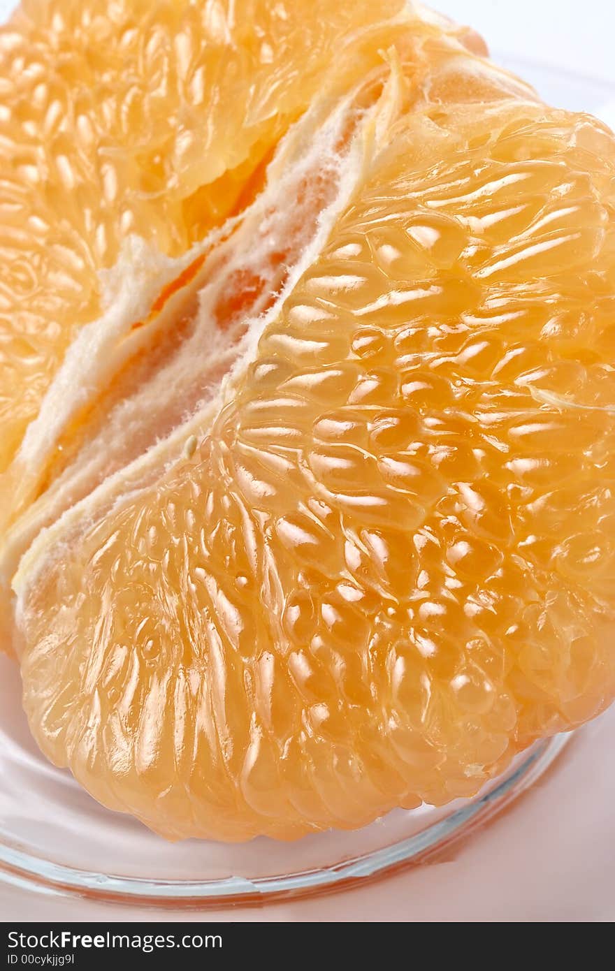 Half Of Grapefruit On A Glass Plate