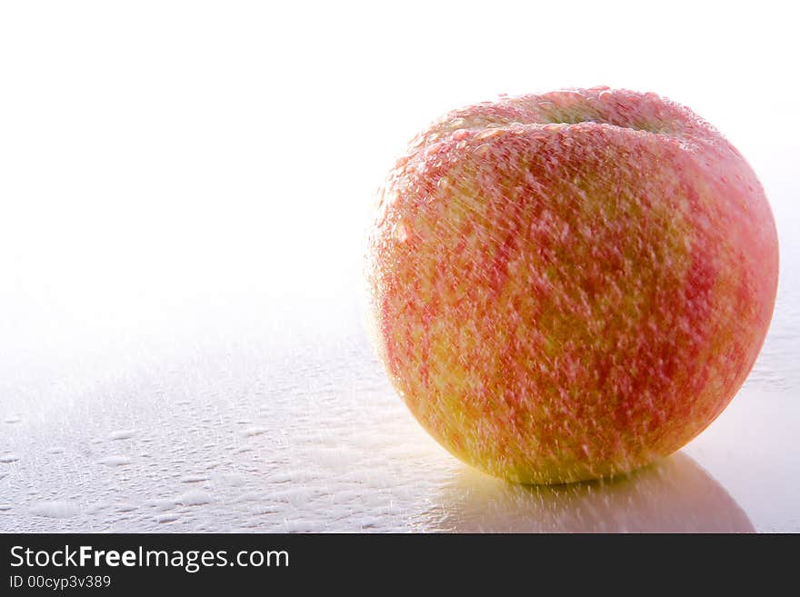 Green fresh apple under rain