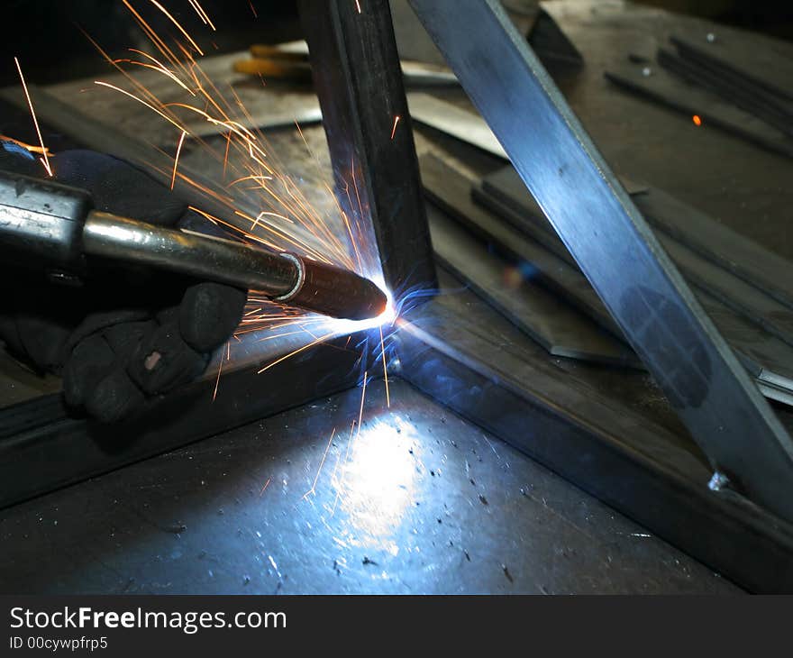 Welder working at metal frame; making sparks. Welder working at metal frame; making sparks