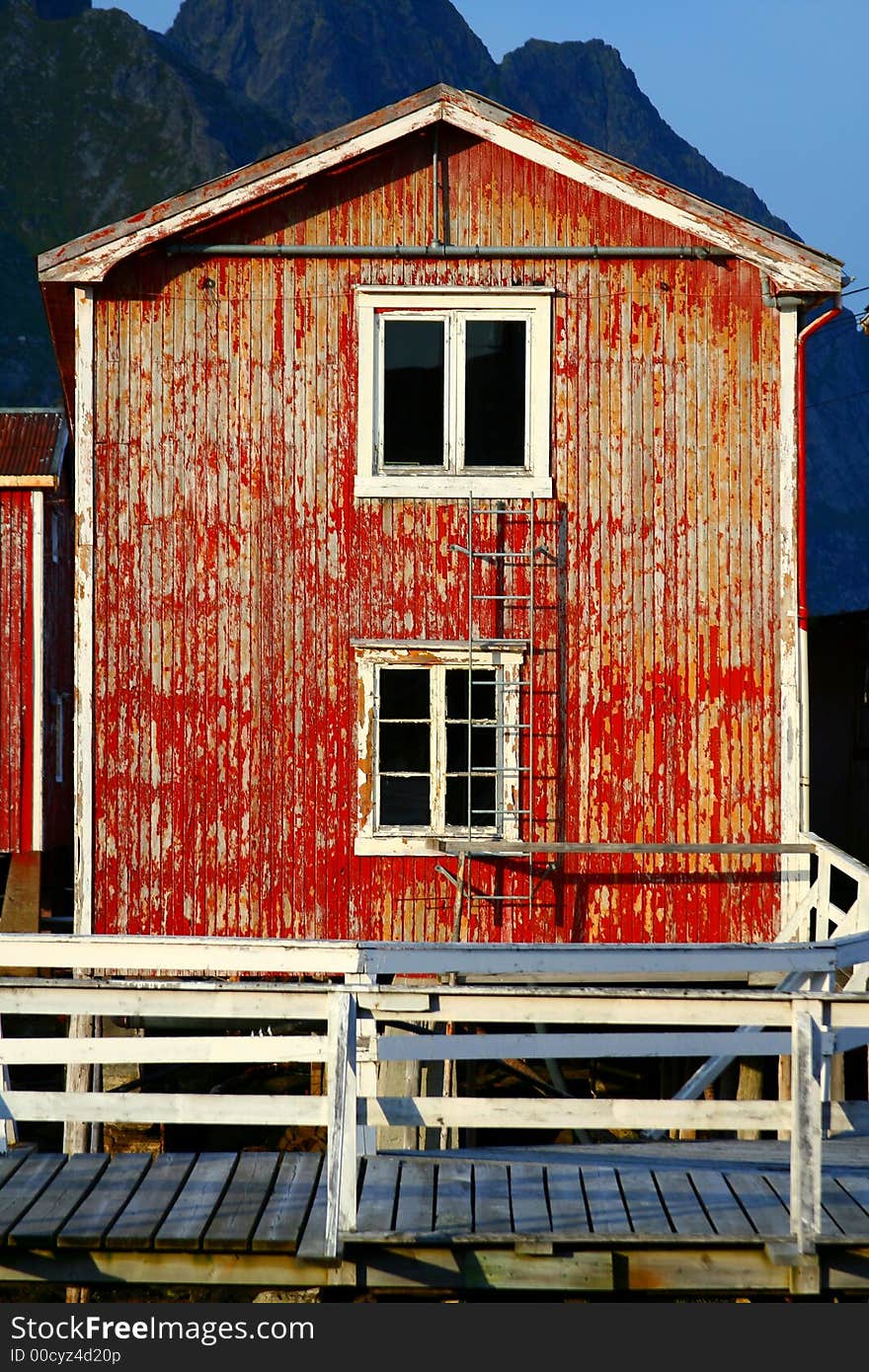 Red wooden house damaged in the lofoten islands