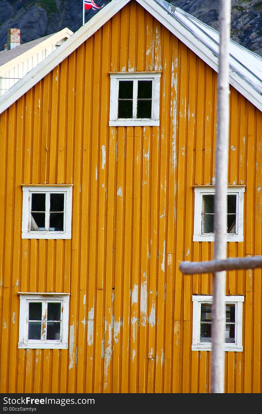 Five windows on a yellow frontage in a typical port of the lofoten islands (norway). Five windows on a yellow frontage in a typical port of the lofoten islands (norway)