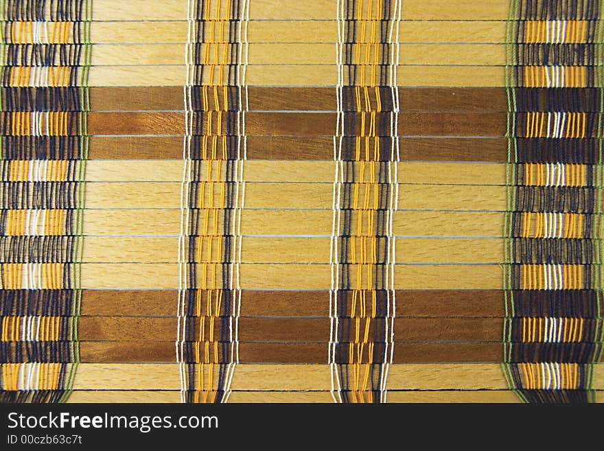 Vintage placemat with natural, unpainted wooden planks and colorful threads - background, texture