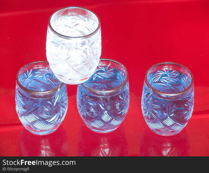 Several blue and white glasses on red background