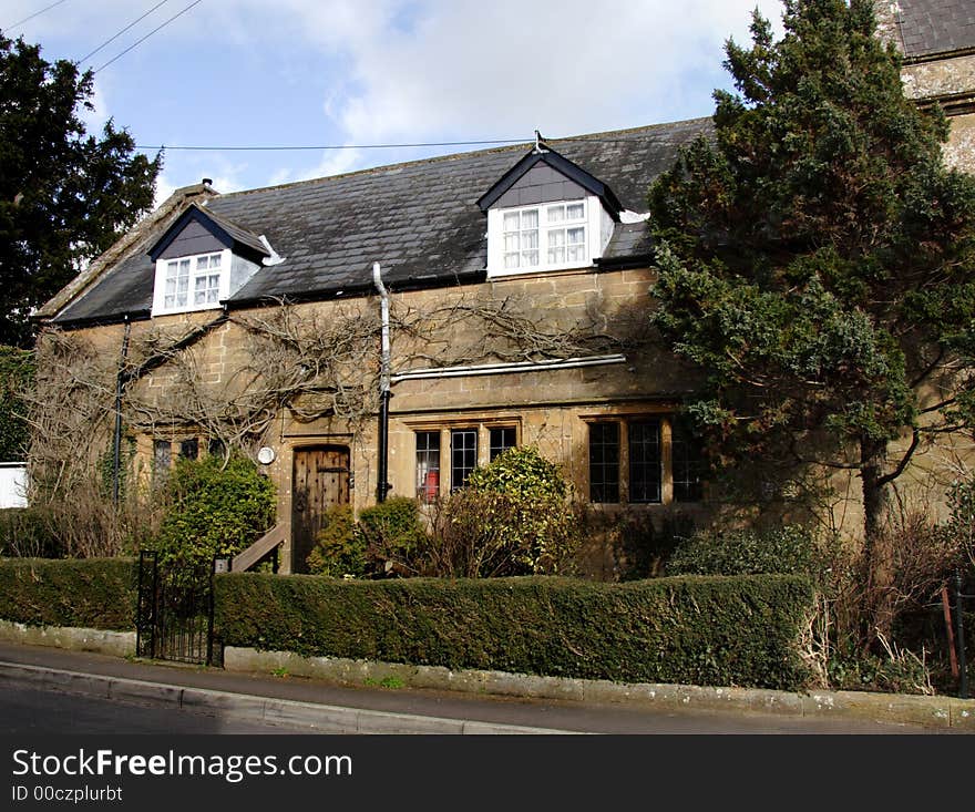 Winter sunshine on a Natural Stone Mullion windowed English Village House