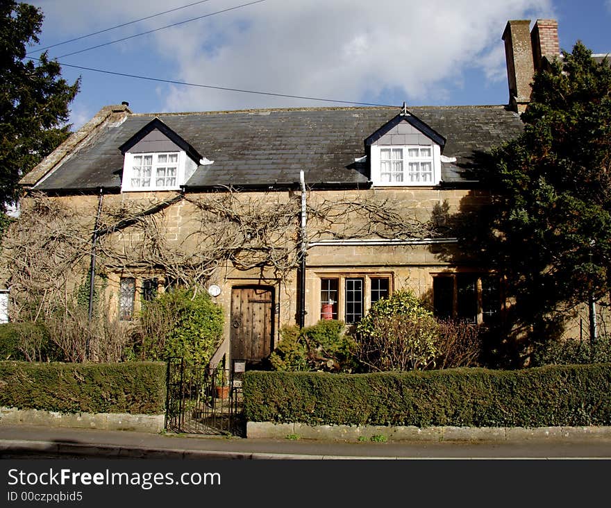 Winter sunshine on a Natural Stone Mullion windowed English Village House