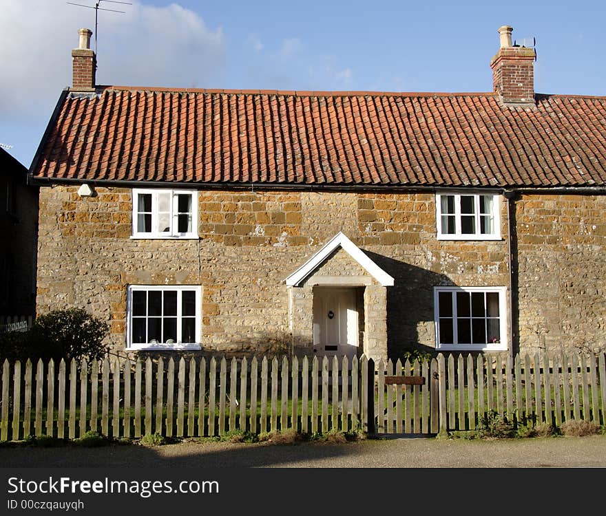 Winter sunshine on a Natural Stone English Village Cottage