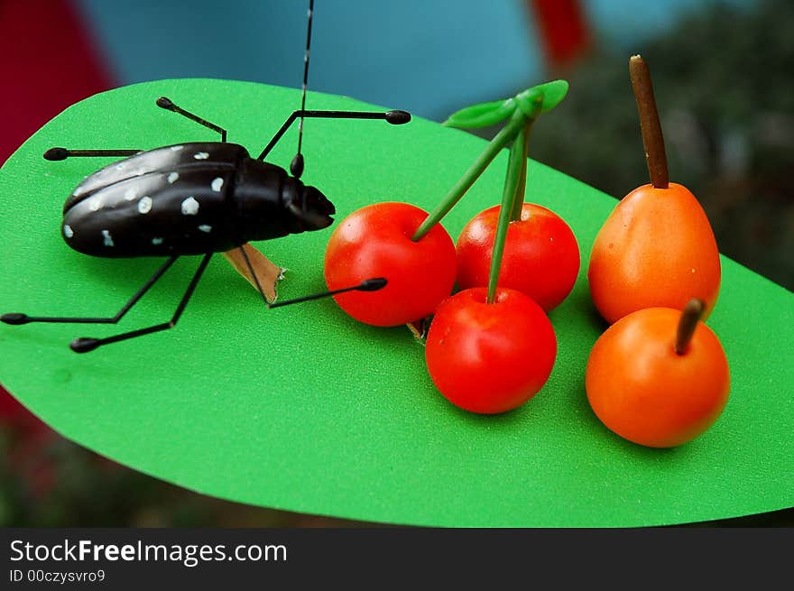 Beetle and cherry made out of plasticine in Sichuan,west of China. Beetle and cherry made out of plasticine in Sichuan,west of China