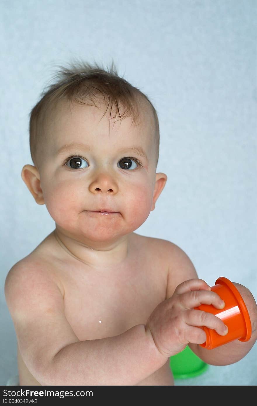 Image of adorable baby playing with stacking cups. Image of adorable baby playing with stacking cups