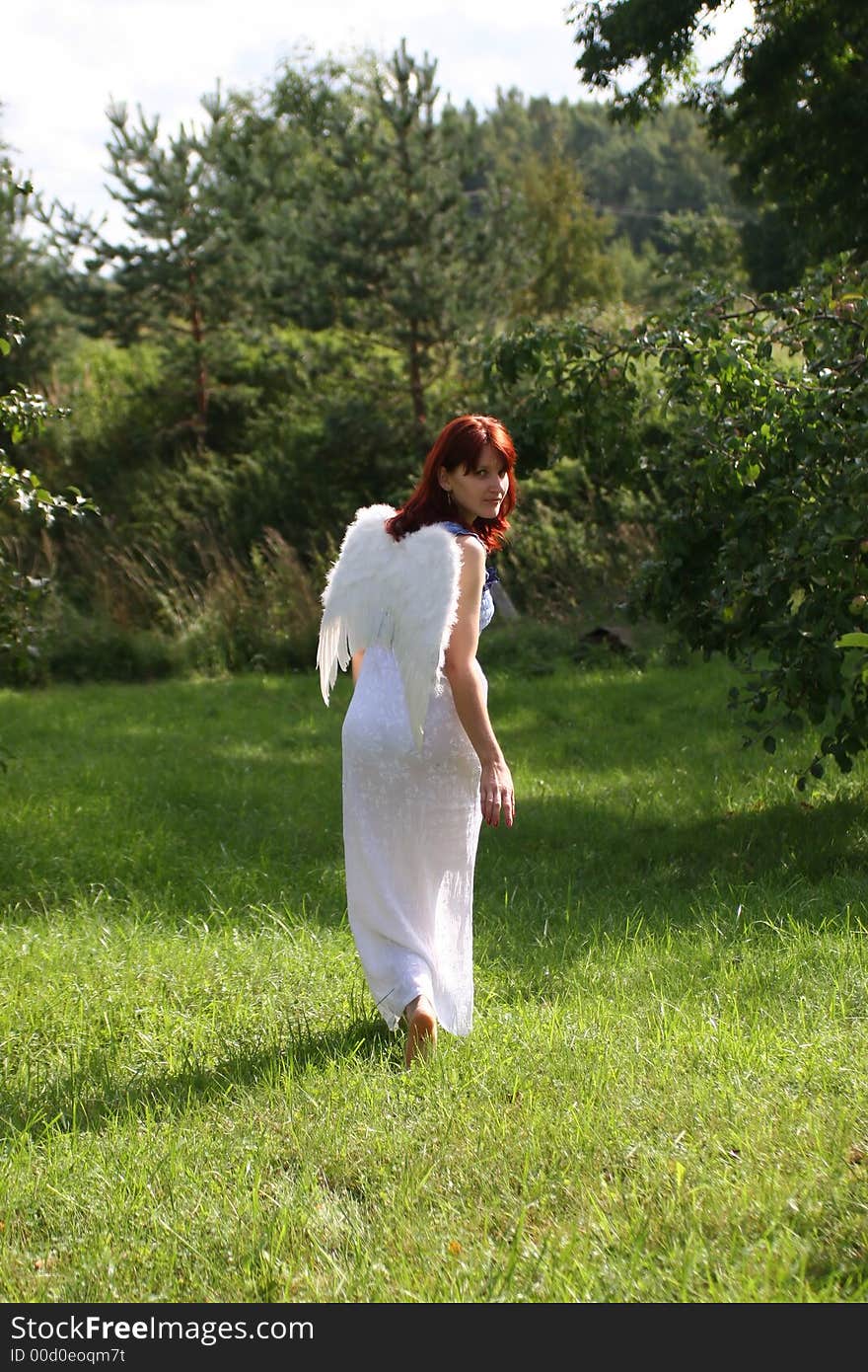 Beautiful leaving angel with brightly red hair