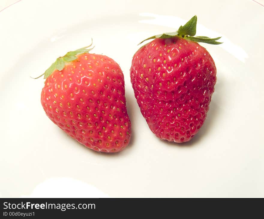 Two red strawberries as spring fruit in the meal