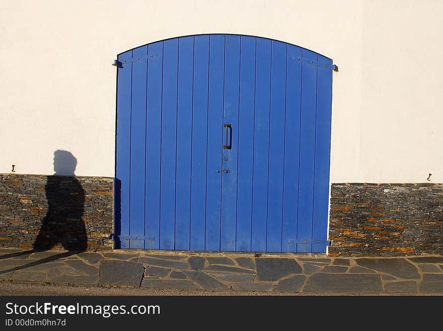 Blue door with shadow infront