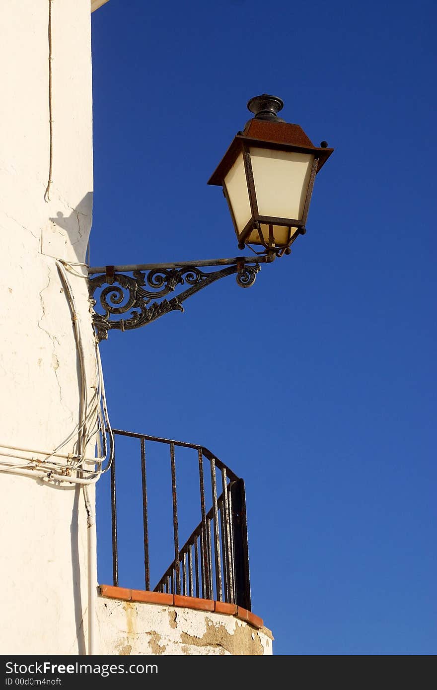 Old street lamp at a corner of the town of Cadaques, Catalonia, Spain, Europe. Old street lamp at a corner of the town of Cadaques, Catalonia, Spain, Europe