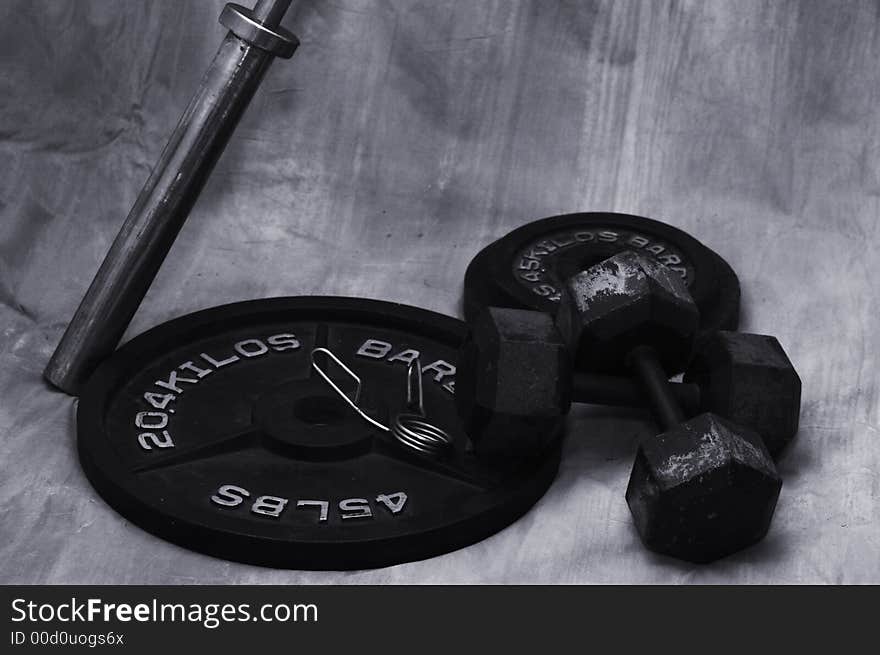 Free weights on ground with brown background. Free weights on ground with brown background