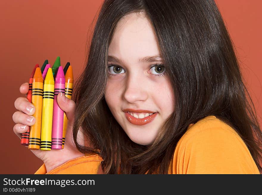 Portrait of pretty girl with colored pencils