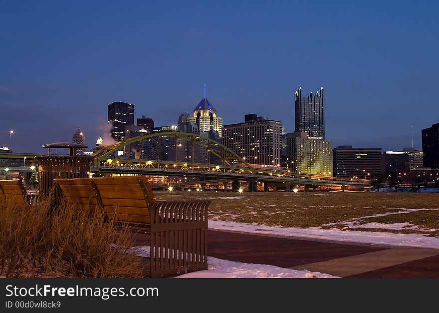 A bench with a view of downtown. A bench with a view of downtown