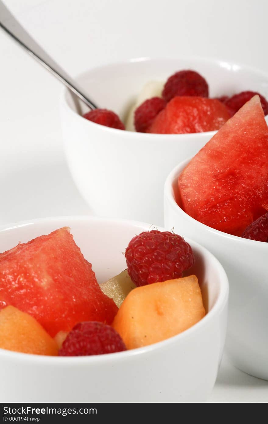 Three bowls of fresh fruit on a white background. Three bowls of fresh fruit on a white background