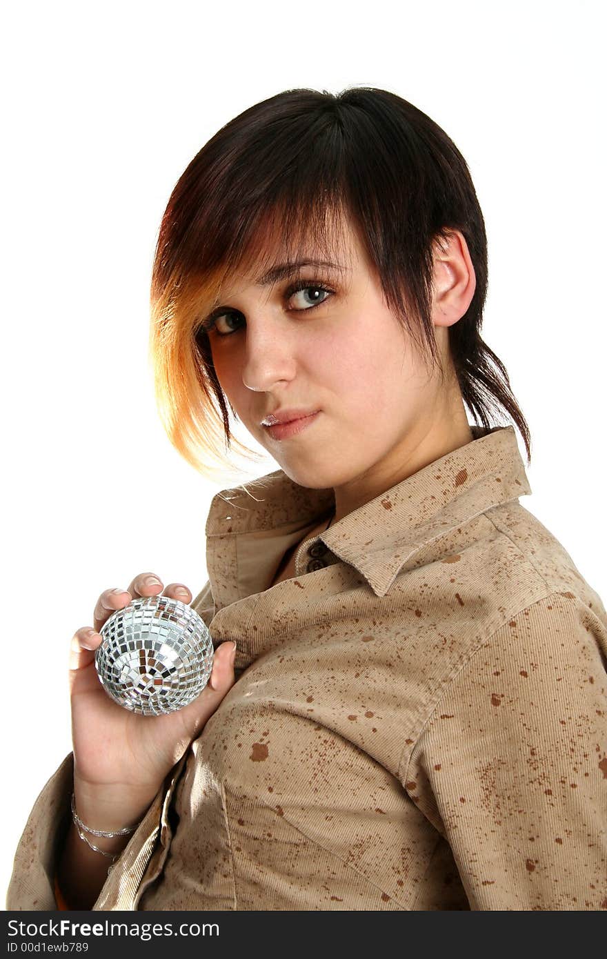 The young girl holds mirror sphere in hand