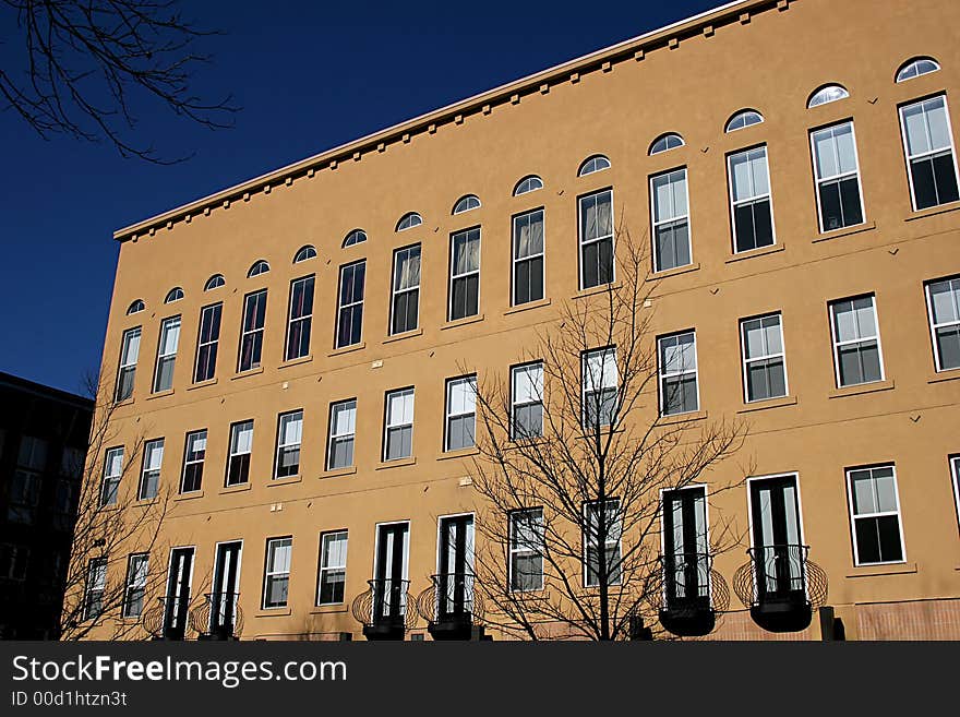 Stucco condominium building on a city street. Stucco condominium building on a city street