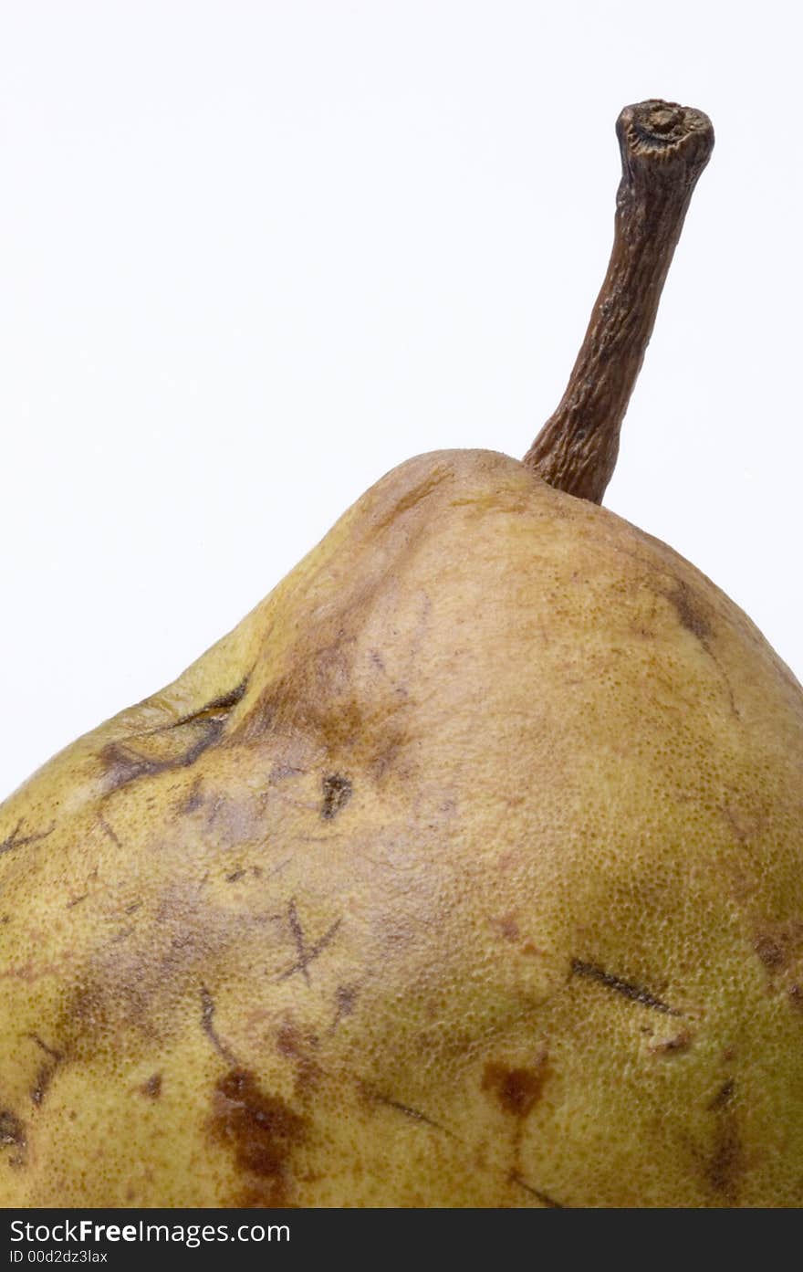 An over ripe pear on a white background symbolizing aging and decay. An over ripe pear on a white background symbolizing aging and decay