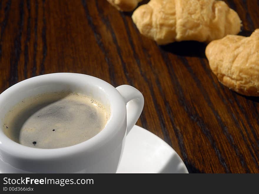 Black coffee and golden croissants. Black coffee and golden croissants