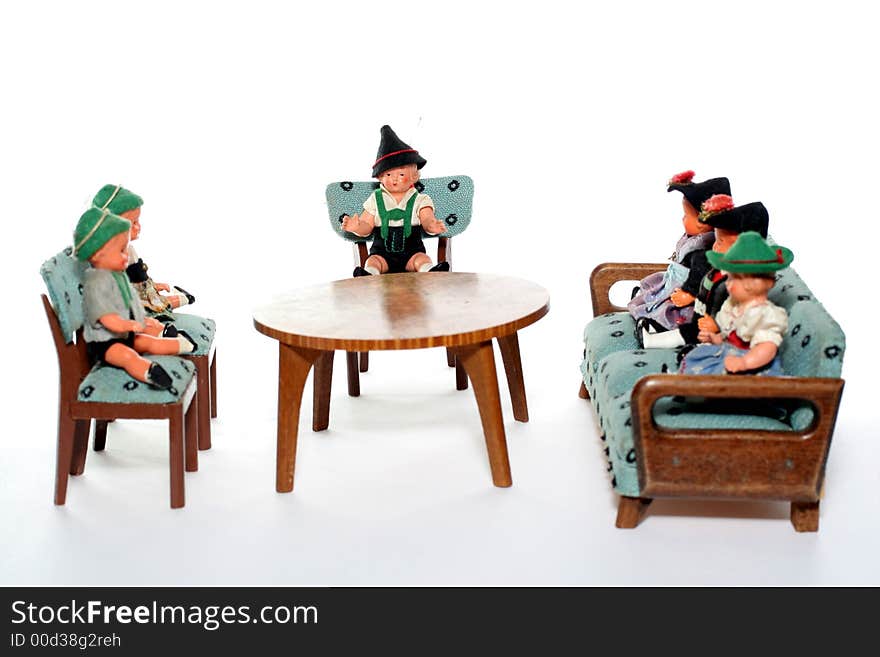 6 dolls in traditional European (I think they are Austrian but not sure) dresses sitting on chairs and couch round a table (old hand made furniture). 6 dolls in traditional European (I think they are Austrian but not sure) dresses sitting on chairs and couch round a table (old hand made furniture).