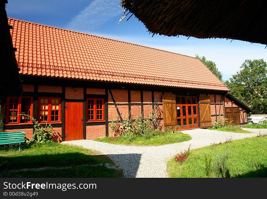 Traditional Polish checked houses, tile roof. Red brick. Traditional Polish checked houses, tile roof. Red brick.