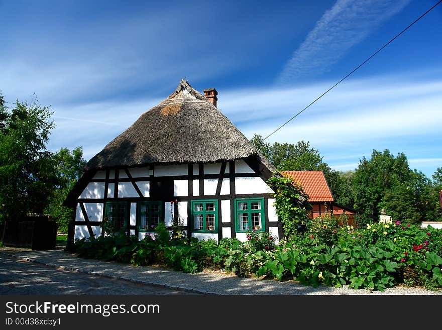 Traditional Polish checked houses, straw roofs. Traditional Polish checked houses, straw roofs.