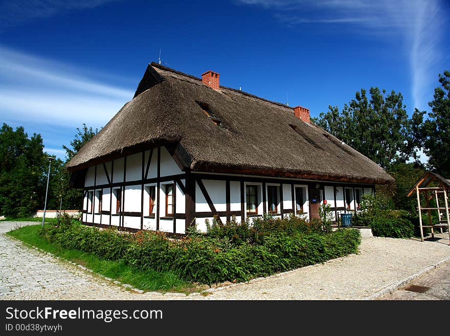 Traditional Polish checked houses, straw roofs. Traditional Polish checked houses, straw roofs.