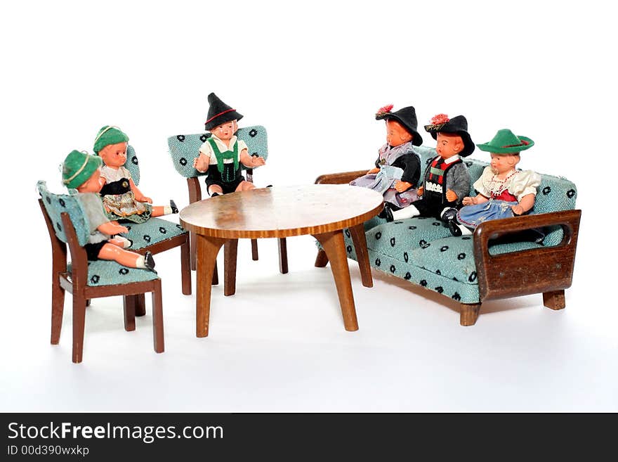 6 dolls in traditional European (I think they are Austrian but not sure) dresses sitting on chairs and couch round a table (old hand made furniture). 6 dolls in traditional European (I think they are Austrian but not sure) dresses sitting on chairs and couch round a table (old hand made furniture).