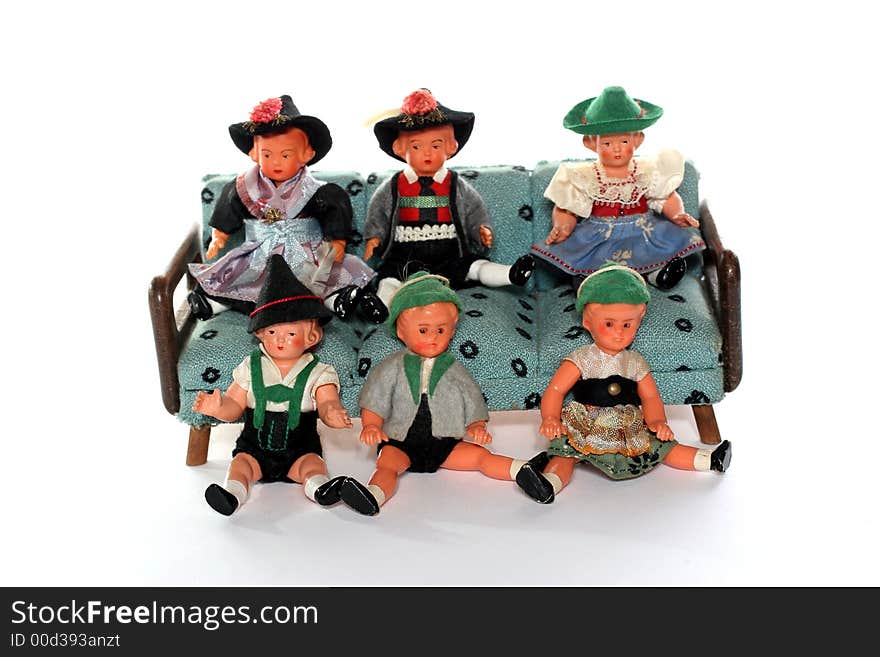 6 dolls in traditional European (I think they are Austrian but not sure) dresses sitting on and infront of a couch (old hand made furniture). 6 dolls in traditional European (I think they are Austrian but not sure) dresses sitting on and infront of a couch (old hand made furniture).