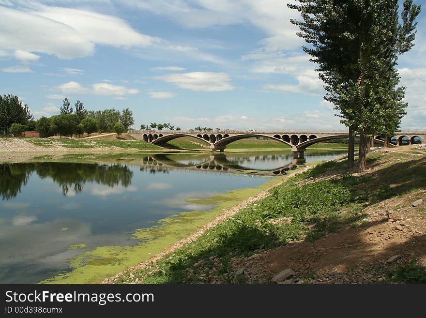 A traditional Chinese bridge across river. The most important character is the holes under the bridge surface. These holes may let water pass through when flood comes, then prevent the bridge from being destroyed by flood.