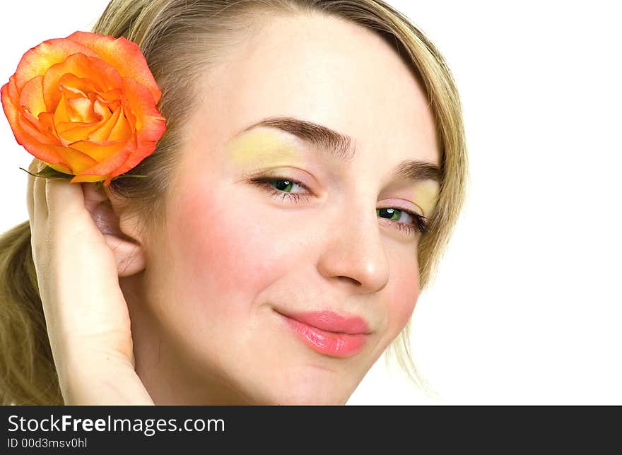 Portrait of beautiful blonde girl with rose in her hair