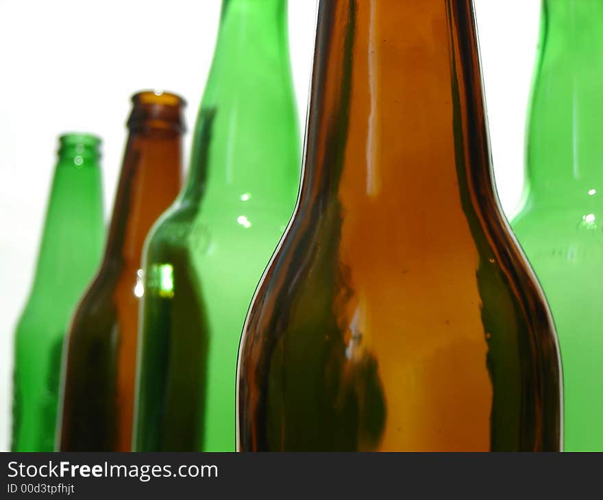 Brown beer bottle in front of green bottles. It`s important to be different. Brown beer bottle in front of green bottles. It`s important to be different.