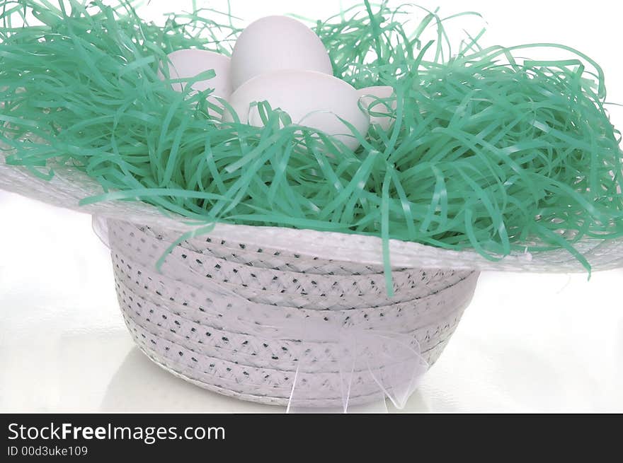 A spring hat filled with easter eggs. White background. A spring hat filled with easter eggs. White background.