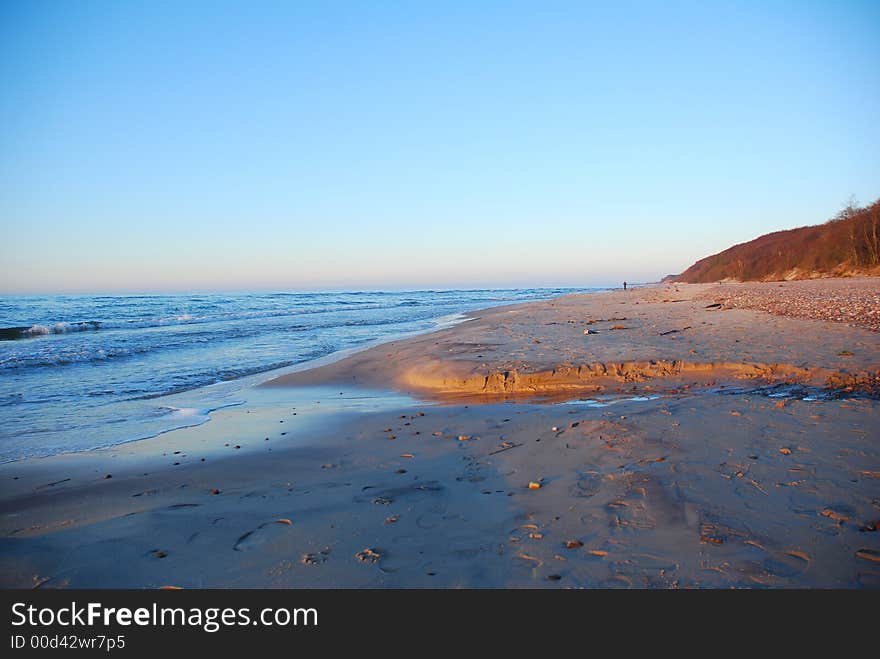 Sandy beach on the blue sky.