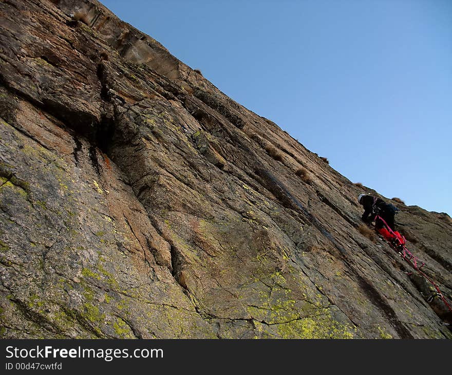 Climber on a granite big wall, West Alps,europe