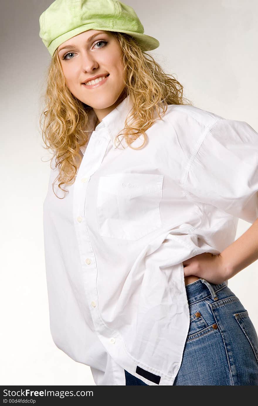 Studio portrait of young beautiful girl dressing wide white shirt