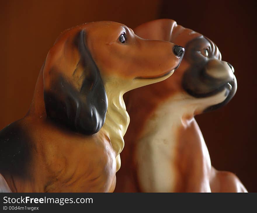 2 Dog Figurines Staring At The Bright Window. 2 Dog Figurines Staring At The Bright Window