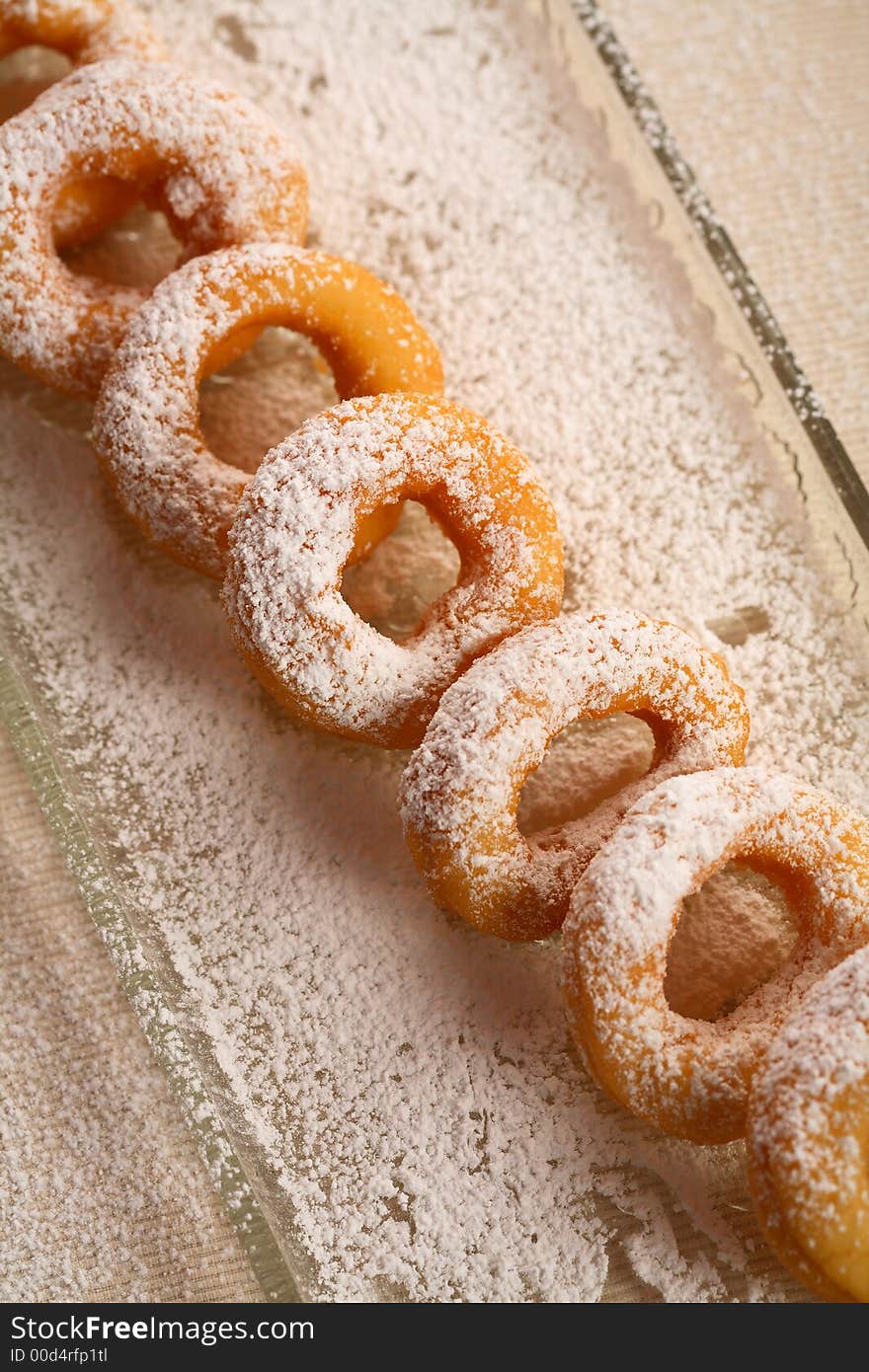 Oval doughnuts with icing sugar put together