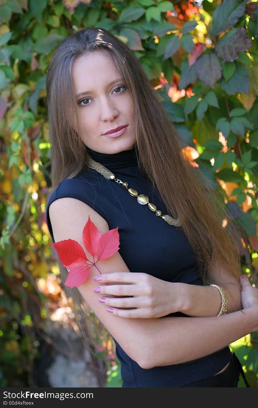 Girl holding a red leaf. Girl holding a red leaf