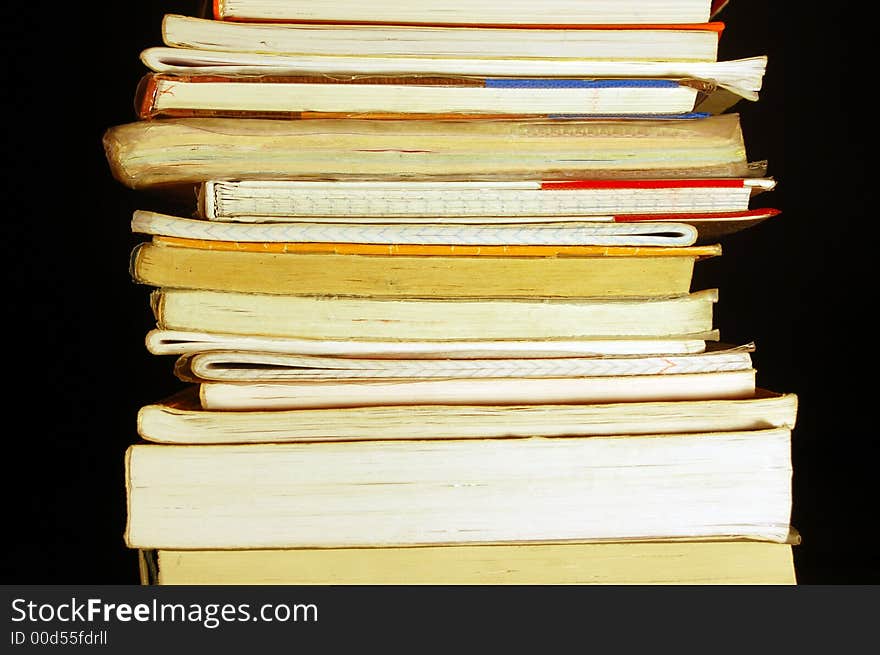 Books pile isolated on black