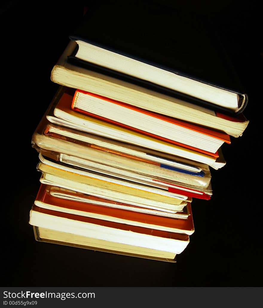 Books pile isolated on black