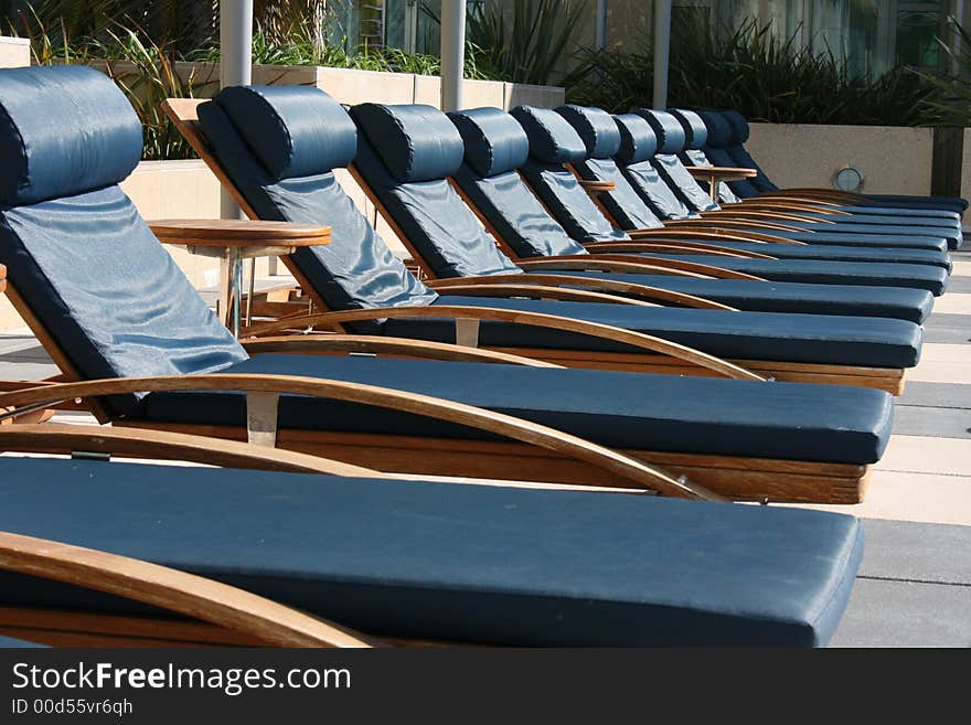 A group of poolside lounge chairs.