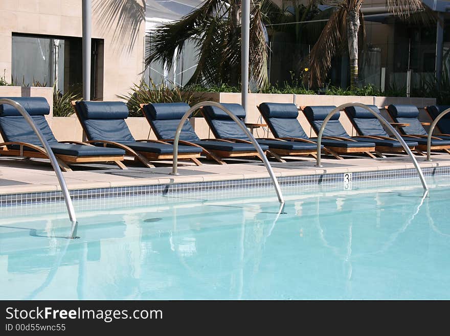 A group of poolside lounge chairs.