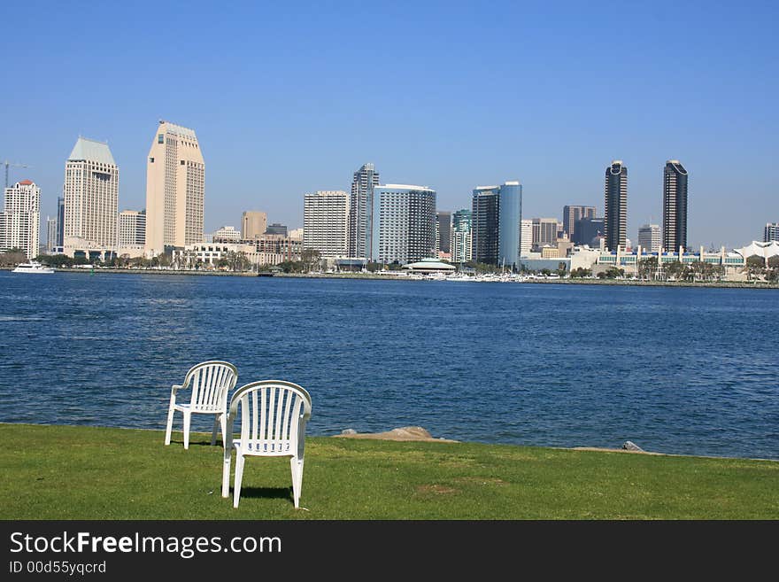 A pair of chairs on the Coronado shore. Downtown San Diego in the background. A pair of chairs on the Coronado shore. Downtown San Diego in the background.