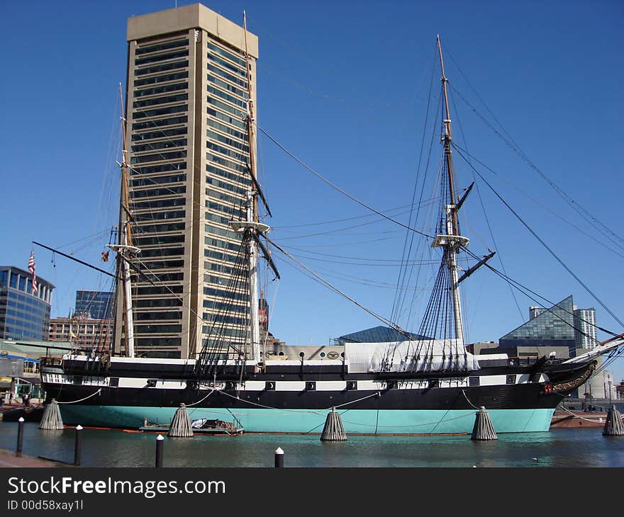 Revolutionary ship docked in a harbor and repainted.