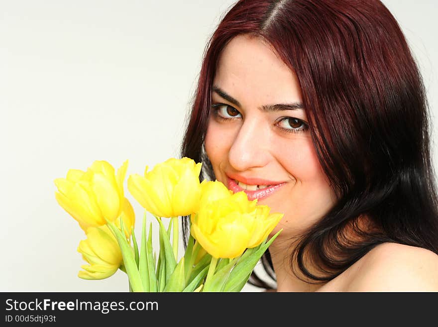 Oriental pretty girl dancing with yellow tulips. Oriental pretty girl dancing with yellow tulips