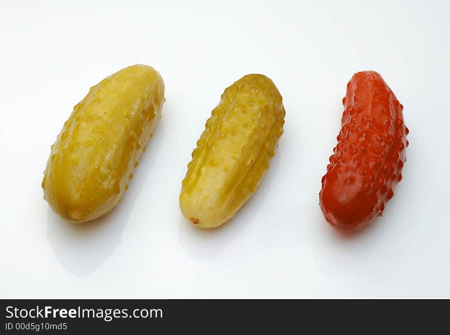 Three cucumbers over white background. Conceptual photo - difference.