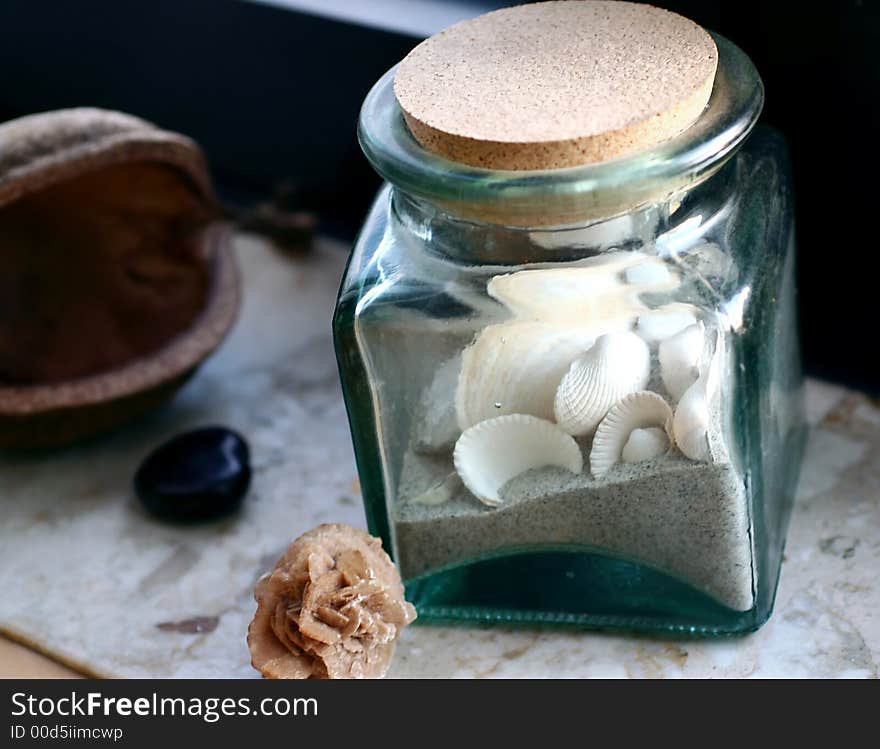 Still life with shells in glass, sand-rose, buddhanut. Still life with shells in glass, sand-rose, buddhanut